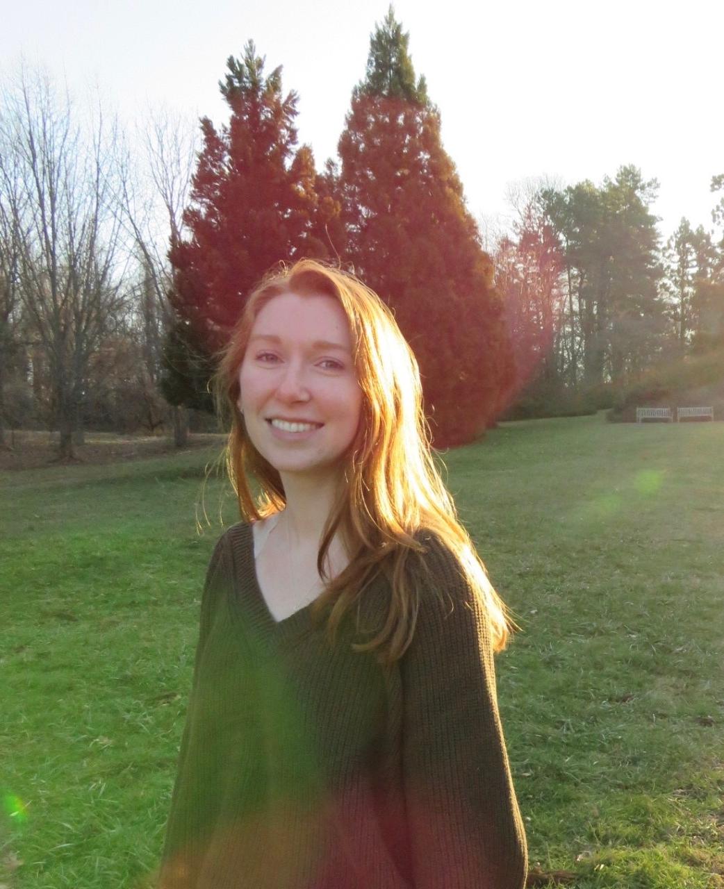 Gillian outside in a field with the sun shining